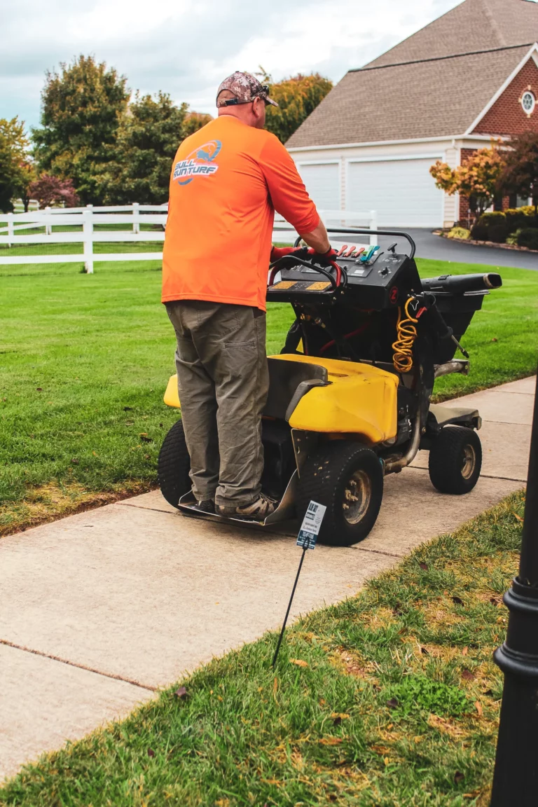 lawn care Chantilly technician applying fertilizer on green residential lawn