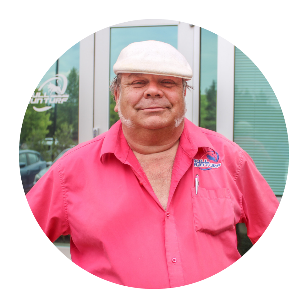 Paul Eden portrait in a white had and magenta shirt- Bull Run Turf and Pest Control