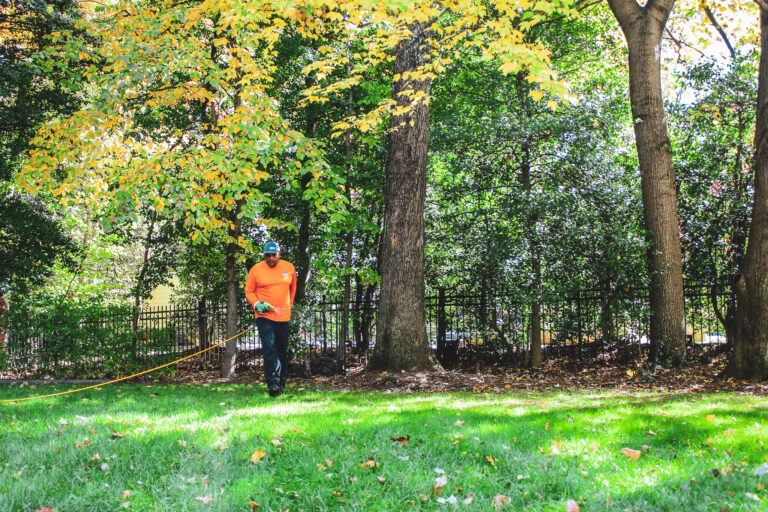 Lawn technician fertilizing residential grass in Chantilly, Virginia
