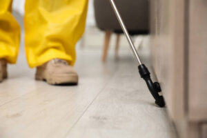 Pest control technician servicing commercial property exterior in Chantilly, Virginia